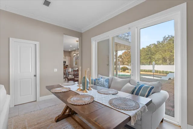 a living room with furniture and a floor to ceiling window