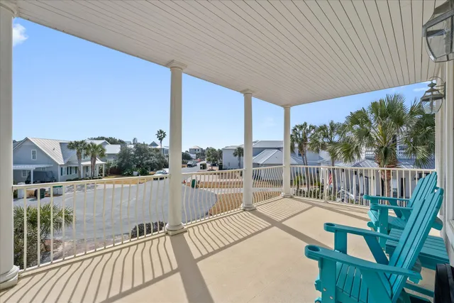 front view of a house with a yard and potted plants