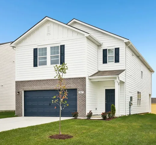 a front view of a house with a yard