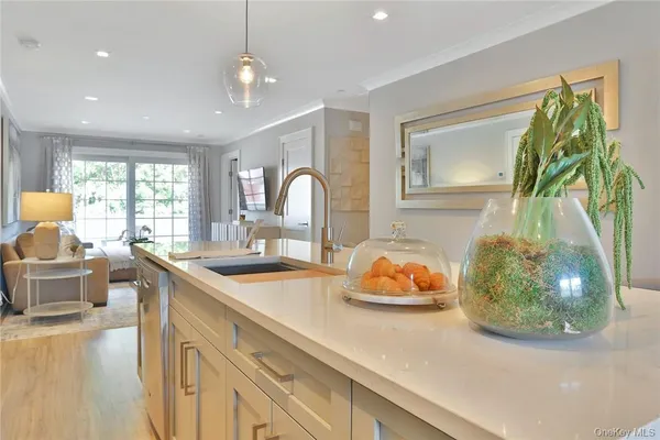 a kitchen with a sink and living room