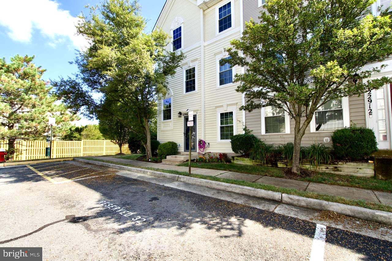 22908 Regent Terrace Sterling, VA 20166 - Photo 1 of 31 a view of a white house next to a road and yard