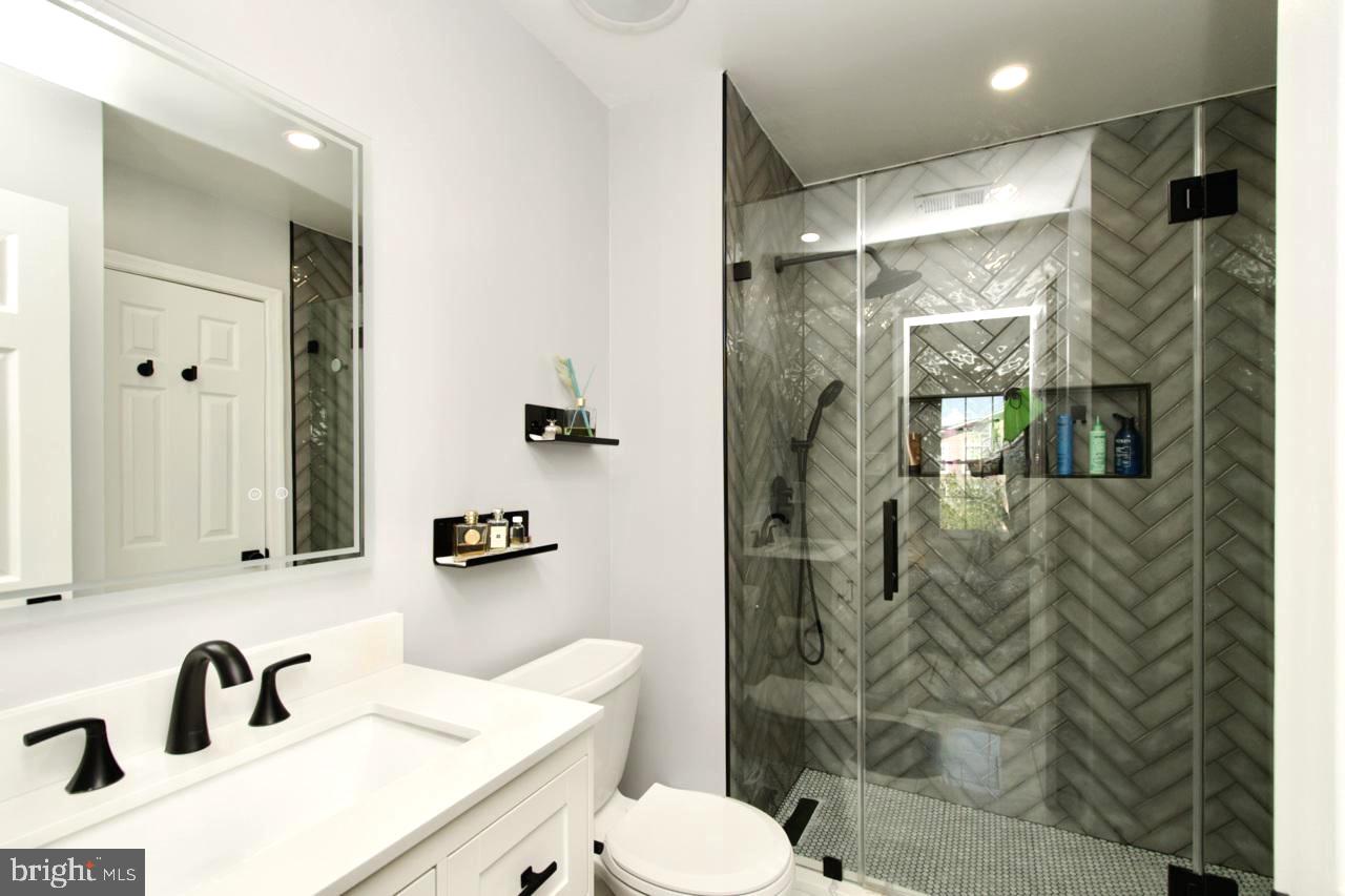 22908 Regent Terrace Sterling, VA 20166 - Photo 17 of 31 a bathroom with a sink toilet and shower