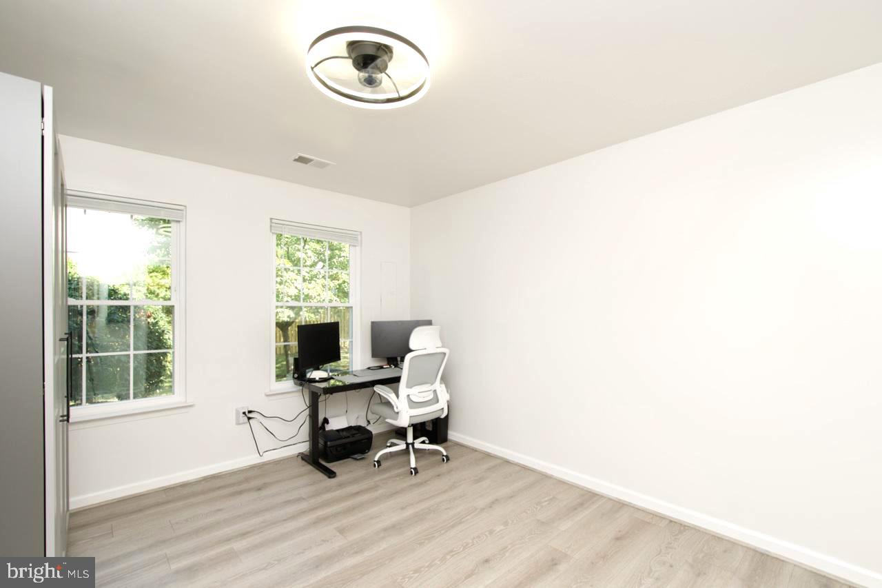 22908 Regent Terrace Sterling, VA 20166 - Photo 18 of 31 a view of a workspace with furniture and a window
