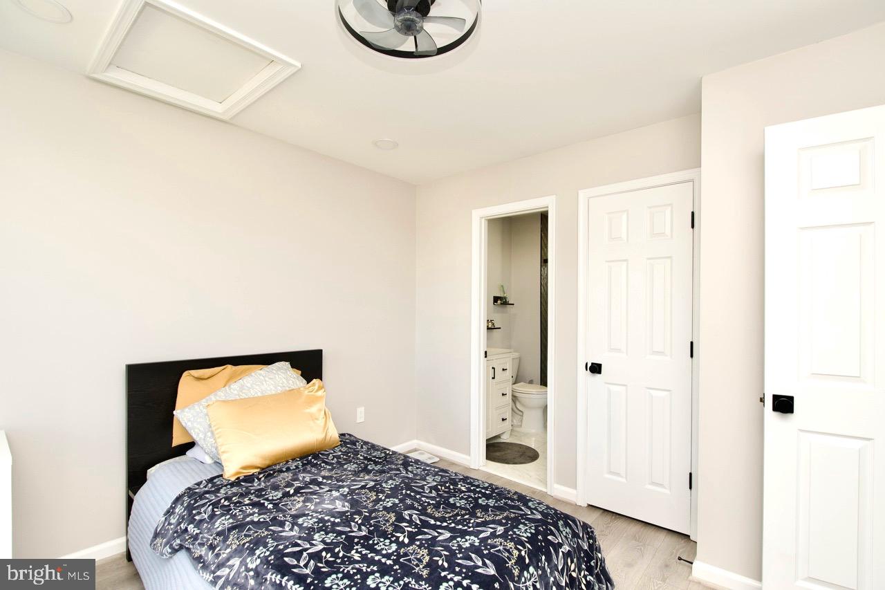 22908 Regent Terrace Sterling, VA 20166 - Photo 19 of 31 a bedroom with a bed and utility room