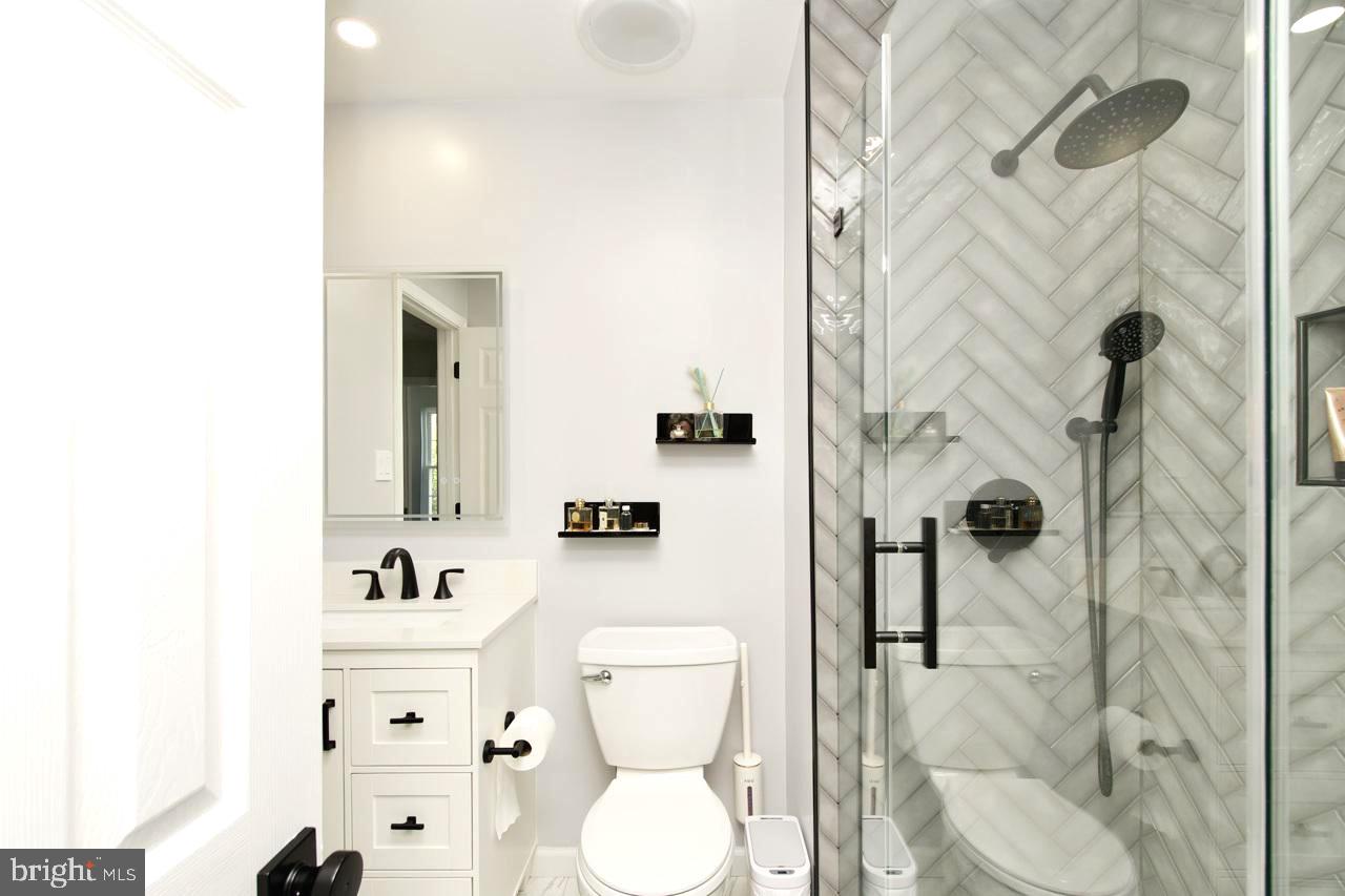 22908 Regent Terrace Sterling, VA 20166 - Photo 20 of 31 a bathroom with a toilet sink and shower curtain