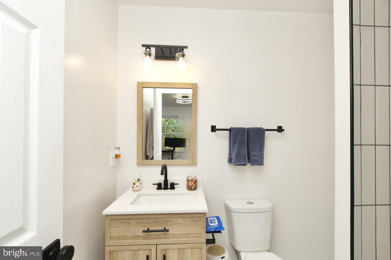 22908 Regent Terrace Sterling, VA 20166 - Photo 26 of 31 a bathroom with a sink vanity mirror and toilet