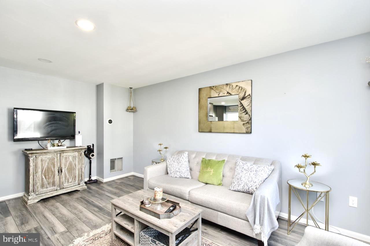 22908 Regent Terrace Sterling, VA 20166 - Photo 5 of 31 a living room with furniture and a flat screen tv
