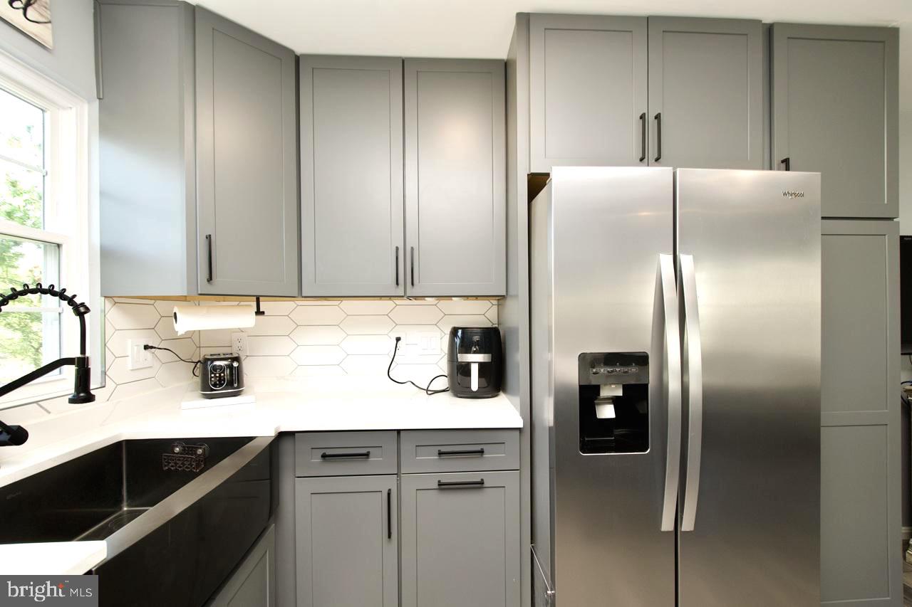 22908 Regent Terrace Sterling, VA 20166 - Photo 10 of 31 a kitchen with a refrigerator and cabinets