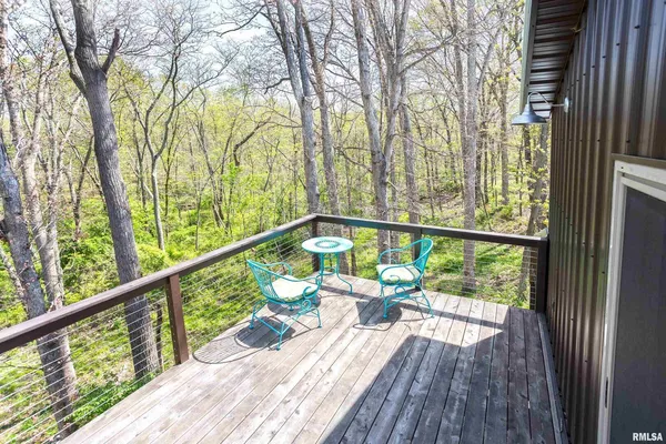 a living room with furniture a rug and a large window