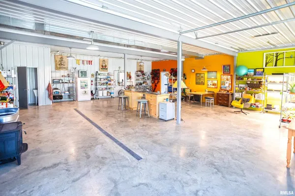 a backyard of a house with barbeque oven and wooden fence