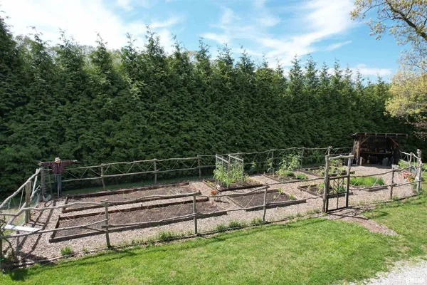 an aerial view of residential houses with outdoor space and trees