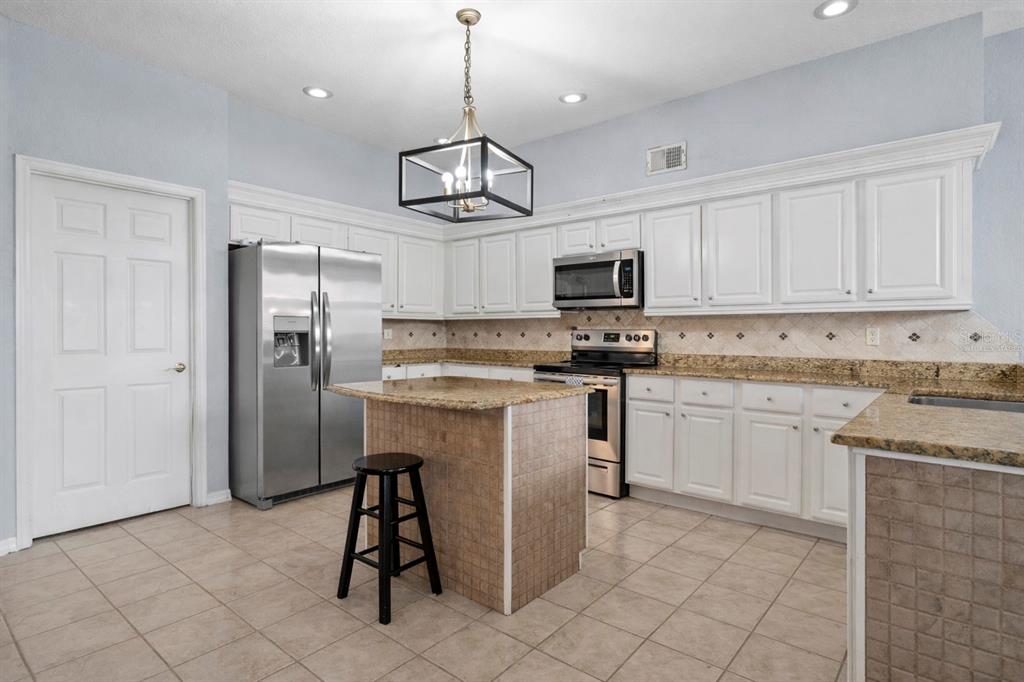 2264 Stone Cross Circle Orlando, FL 32828 - Photo 11 of 45 a kitchen with stainless steel appliances granite countertop a refrigerator and microwave