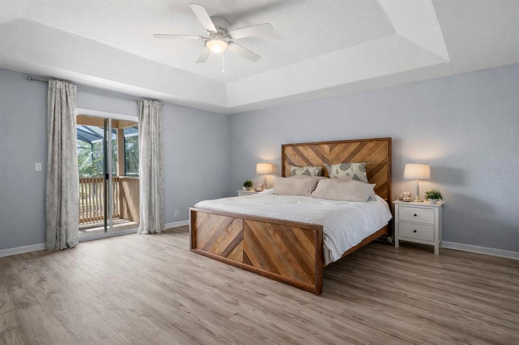 2264 Stone Cross Circle Orlando, FL 32828 - Photo 17 of 45 a bedroom with a bed and wooden floor
