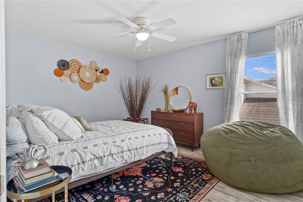 2264 Stone Cross Circle Orlando, FL 32828 - Photo 25 of 45 a bedroom with a bed and a chandelier