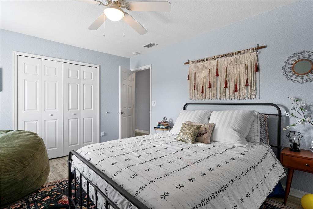 2264 Stone Cross Circle Orlando, FL 32828 - Photo 26 of 45 a bedroom with a bed and a chandelier