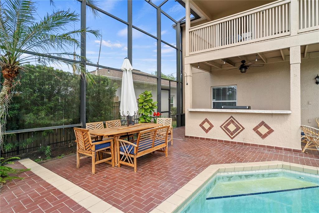 2264 Stone Cross Circle Orlando, FL 32828 - Photo 30 of 45 a backyard of a house with wooden floor a fire pit and furniture