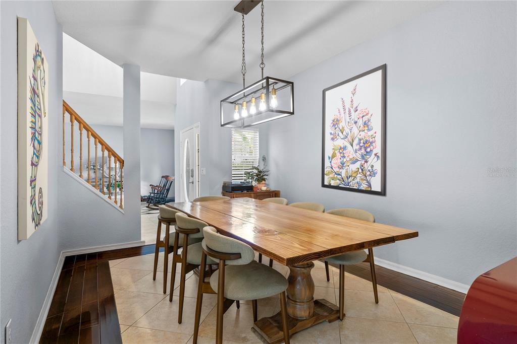 2264 Stone Cross Circle Orlando, FL 32828 - Photo 7 of 45 a view of a dining room with furniture and wooden floor