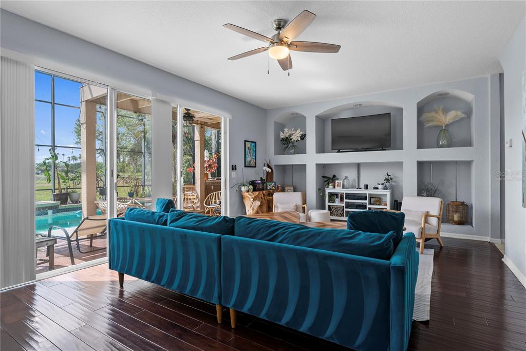 2264 Stone Cross Circle Orlando, FL 32828 - Photo 10 of 45 a living room with furniture fireplace and a large window