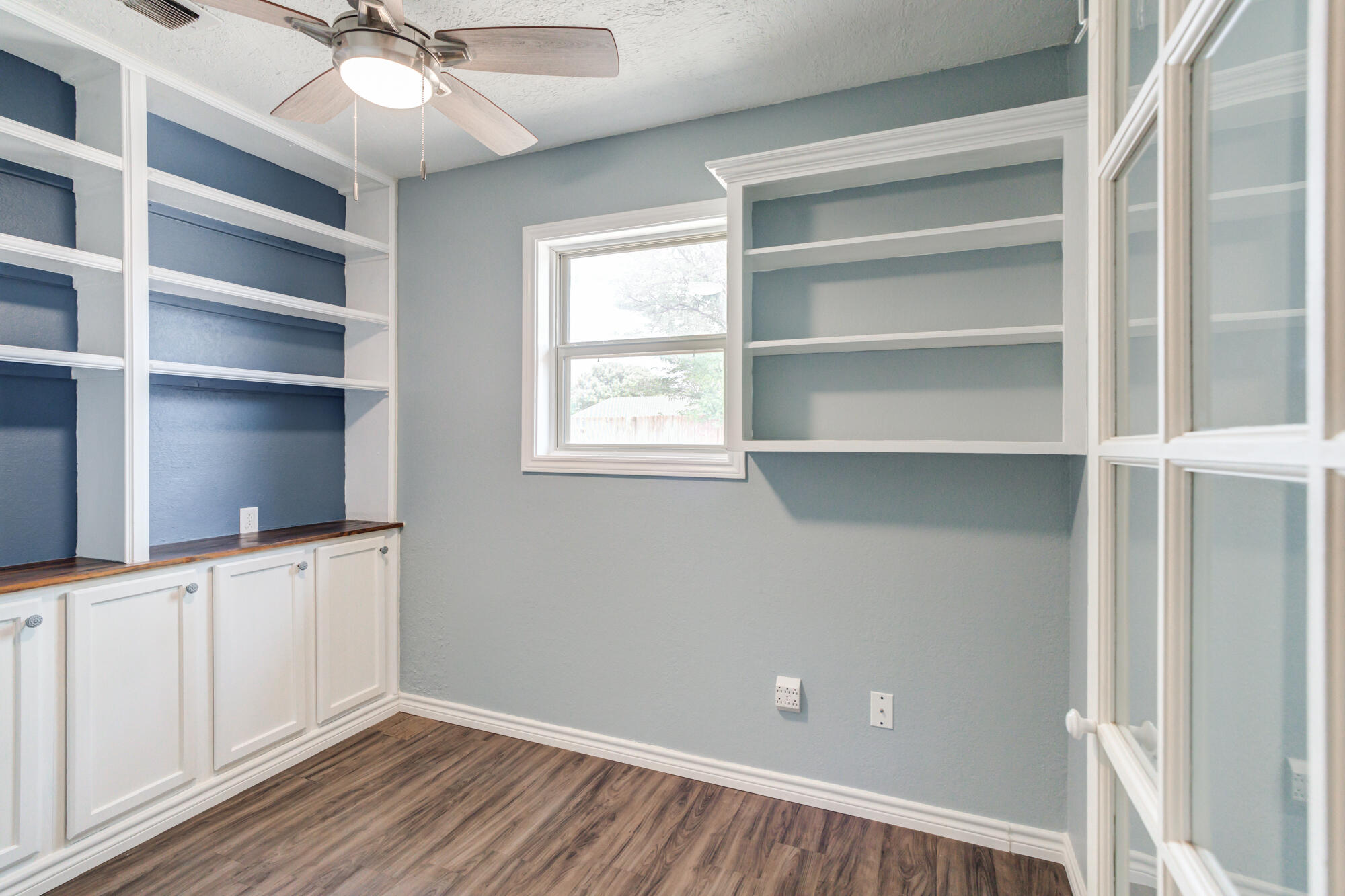 26 Highland Drive Ransom Canyon, TX 79366 - Photo 27 of 53 a view of an empty room with a window and wooden floor