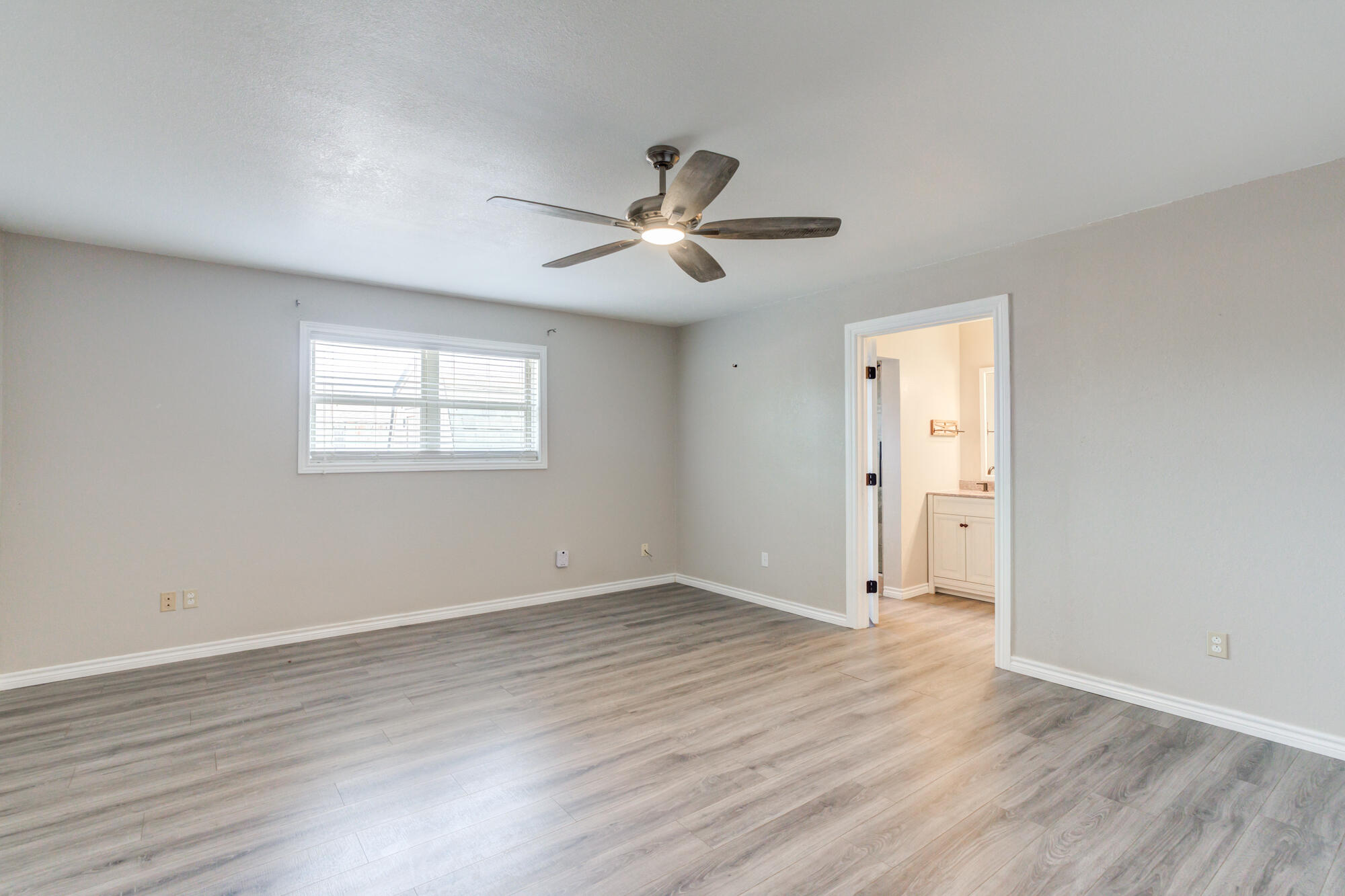 26 Highland Drive Ransom Canyon, TX 79366 - Photo 29 of 53 a view of empty room with wooden floor and fan