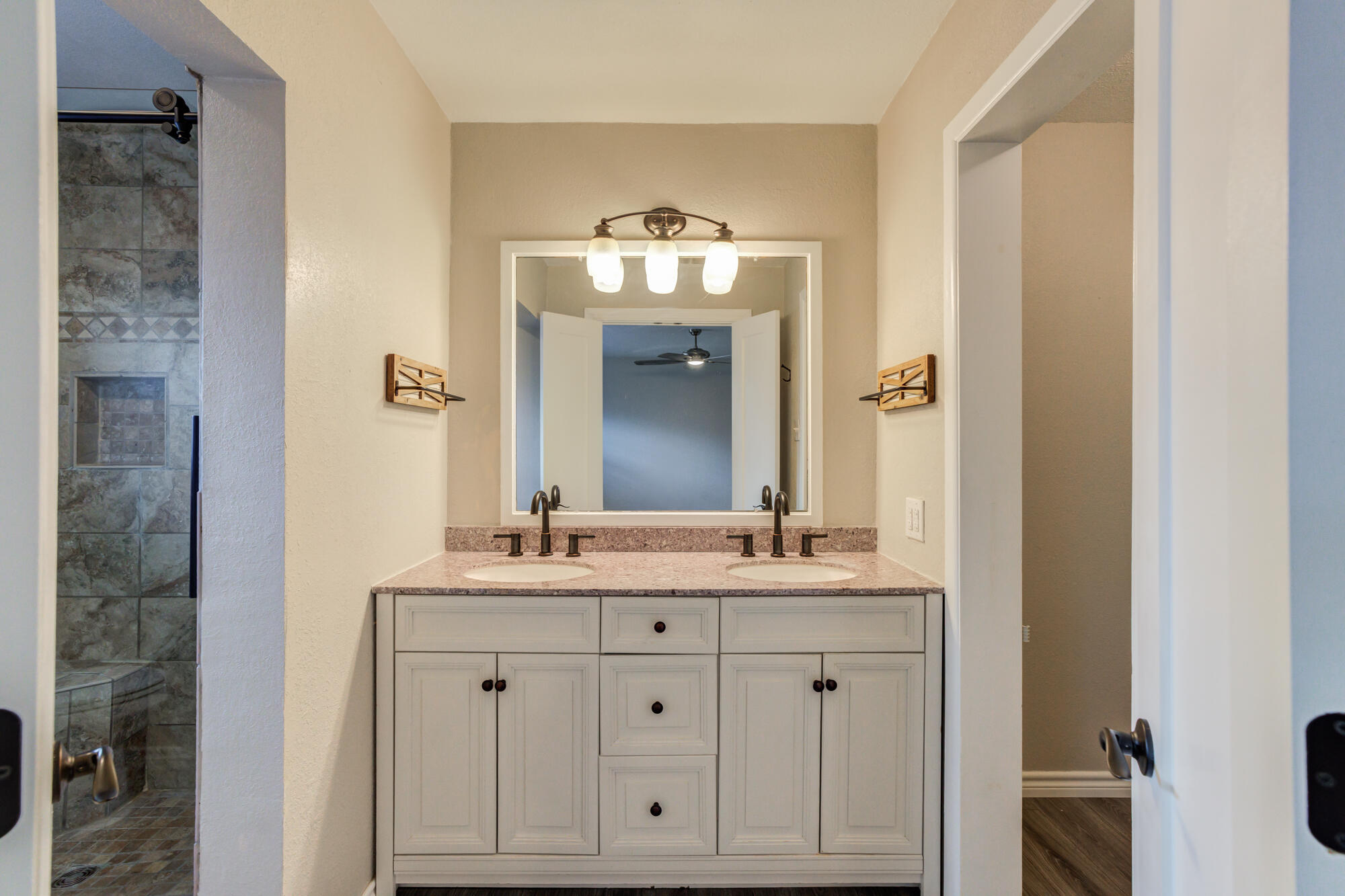 26 Highland Drive Ransom Canyon, TX 79366 - Photo 31 of 53 a bathroom with a double vanity sink and a mirror
