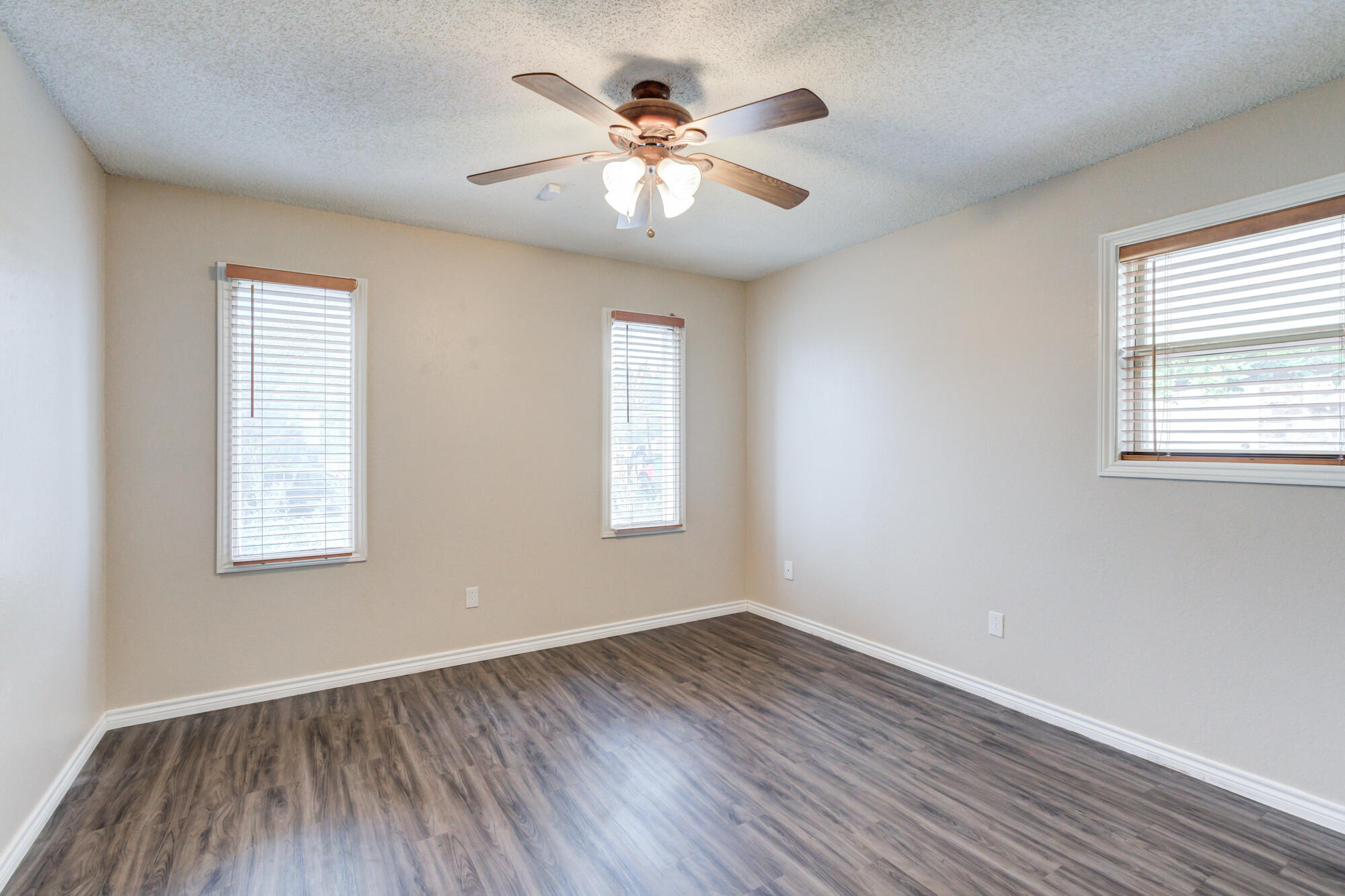 26 Highland Drive Ransom Canyon, TX 79366 - Photo 34 of 53 an empty room with wooden floor and windows