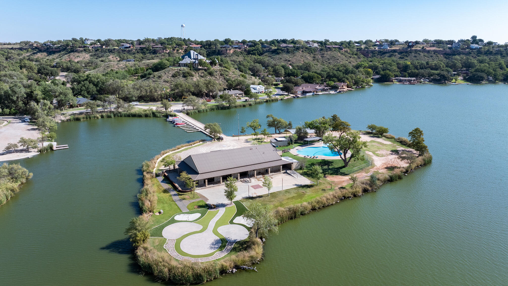 26 Highland Drive Ransom Canyon, TX 79366 - Photo 4 of 53 an aerial view of a house with outdoor space swimming pool and lake view