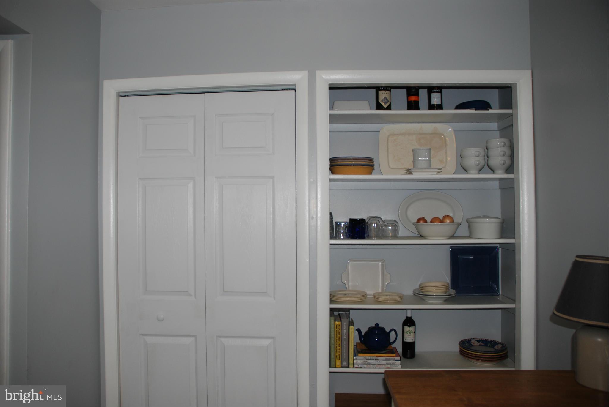 107 Cross Keys Road, Unit R107E Baltimore, MD 21210 - Photo 6 of 14 a shelf with cup and plates