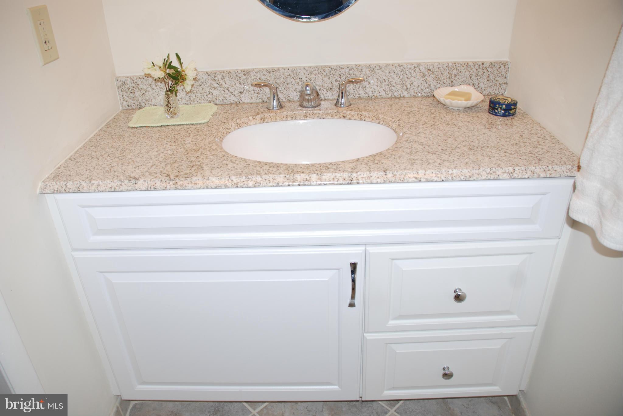 107 Cross Keys Road, Unit R107E Baltimore, MD 21210 - Photo 8 of 14 a bathroom with sink and mirror