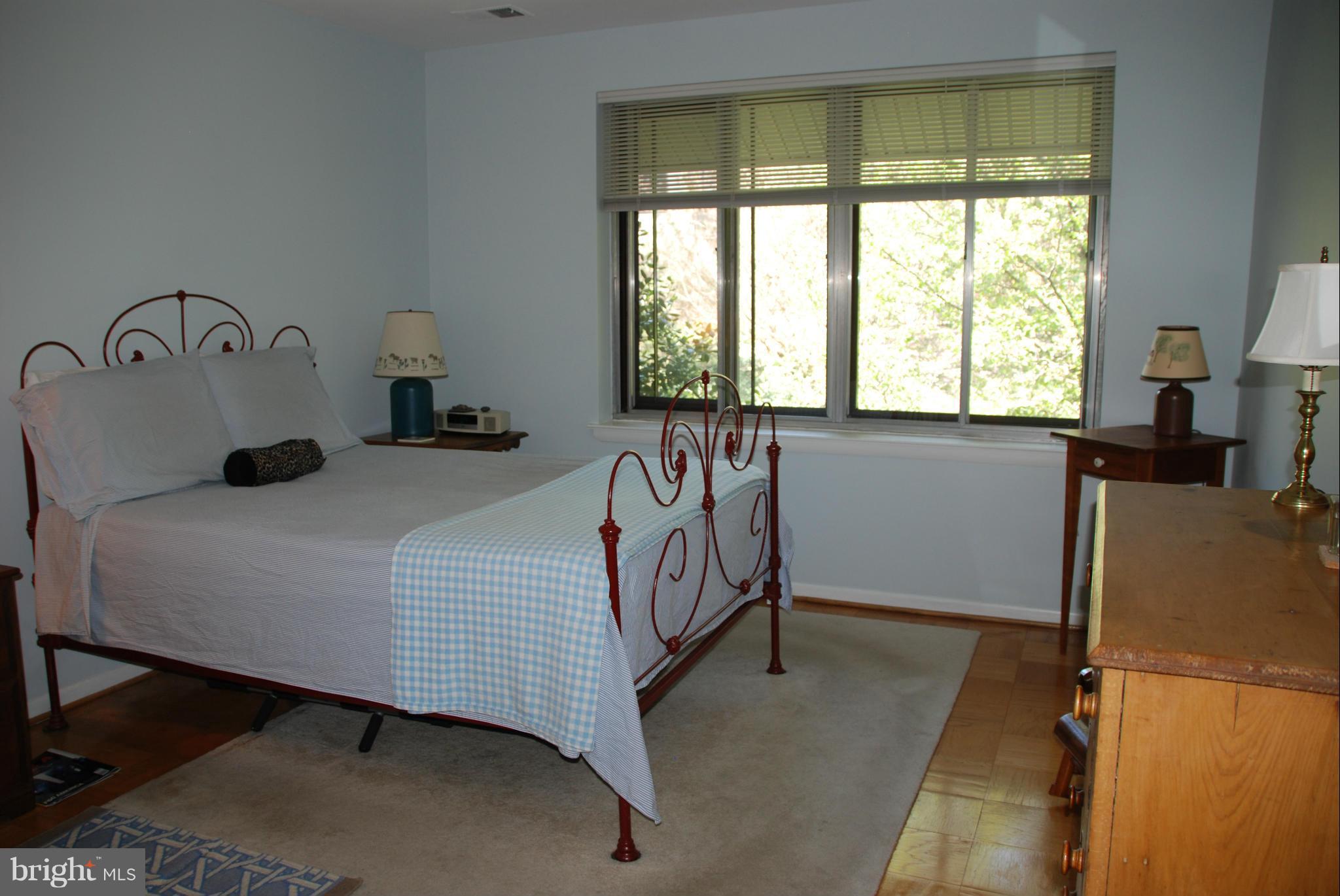 107 Cross Keys Road, Unit R107E Baltimore, MD 21210 - Photo 9 of 14 a bedroom with a bed and a window