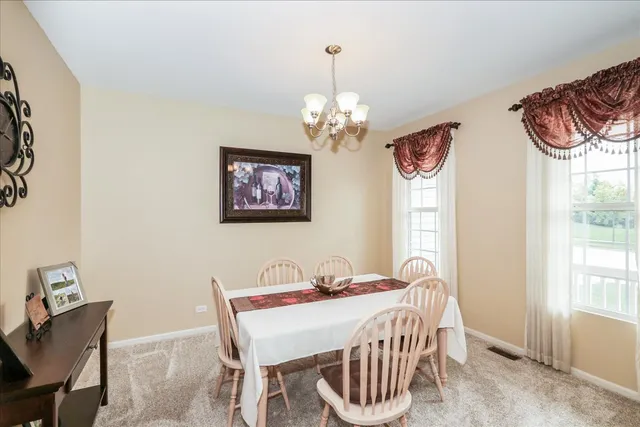 a view of a dining room with furniture window and outside view