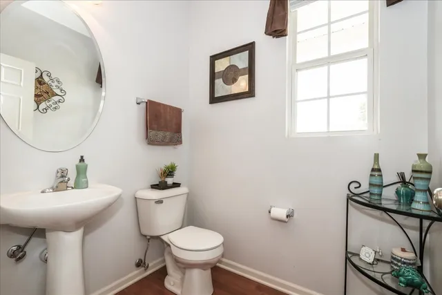 a bathroom with a sink toilet and a mirror