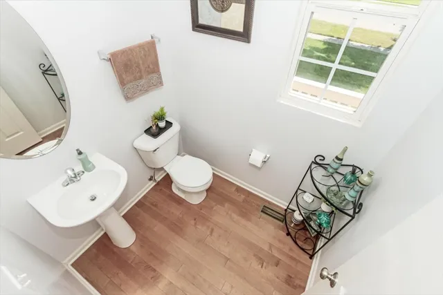 a bathroom with a sink mirror and toilet