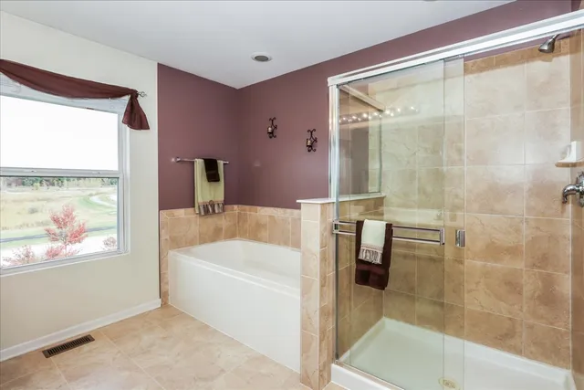 a bathroom with a bathtub and a shower