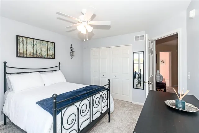 a view of a hallway to a livingroom with furniture