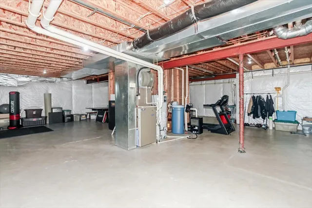 a view of a big room with air conditioner duct and materials on floor