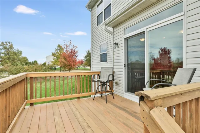 a balcony with furniture and a wooden floor
