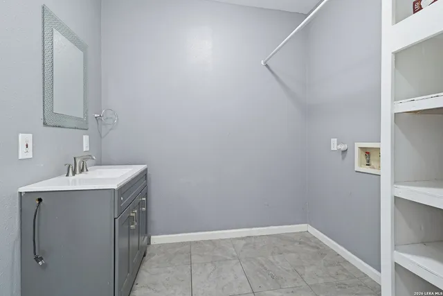 a bathroom with a sink a vanity and mirror