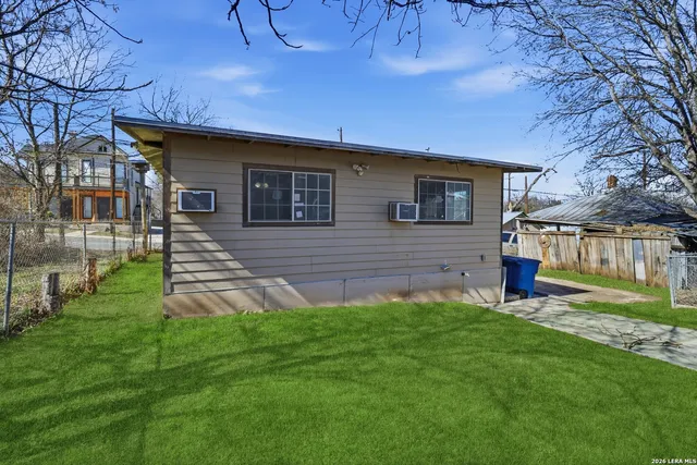 a front view of a house with a yard and outdoor seating