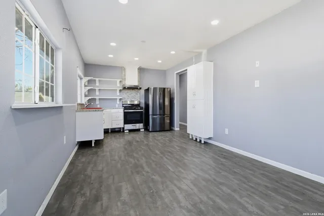 a view of kitchen with refrigerator and window