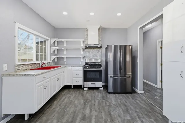 a kitchen with a refrigerator and a sink