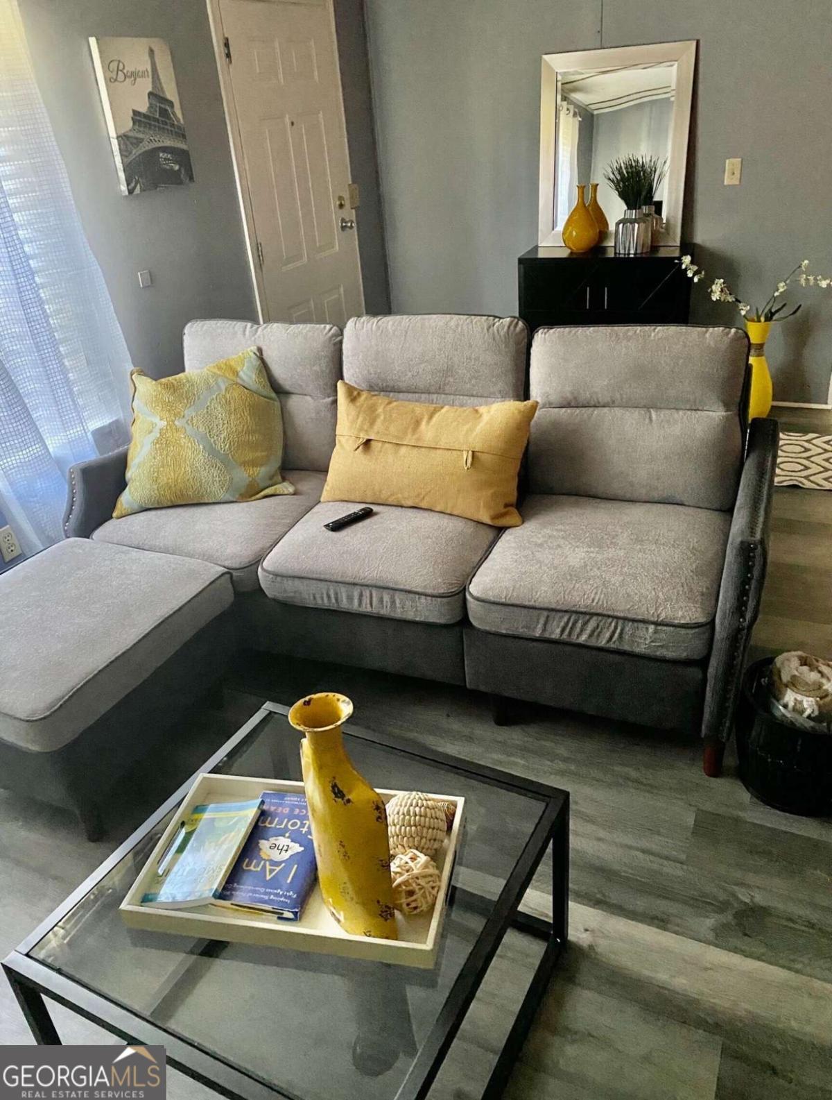 132 Fourth Street Southwest Milledgeville, GA 31061 - Photo 3 of 6 a living room with furniture and a lamp