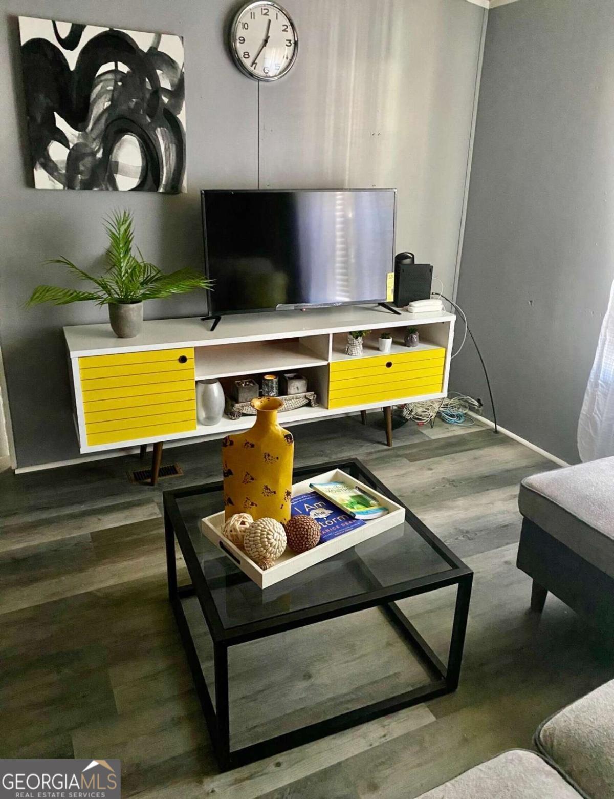 132 Fourth Street Southwest Milledgeville, GA 31061 - Photo 4 of 6 a living room with furniture and a flat screen tv