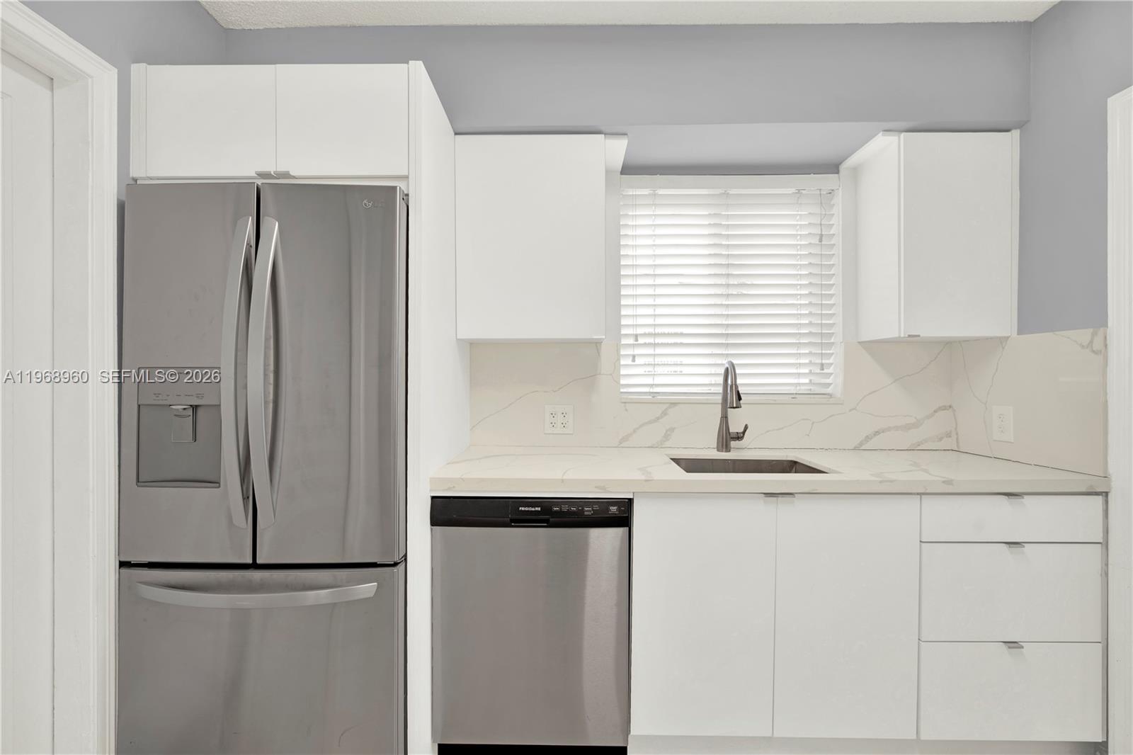 2001 Southwest 37th Avenue Miami, FL 33145 - Photo 11 of 31 a kitchen with a refrigerator and a sink