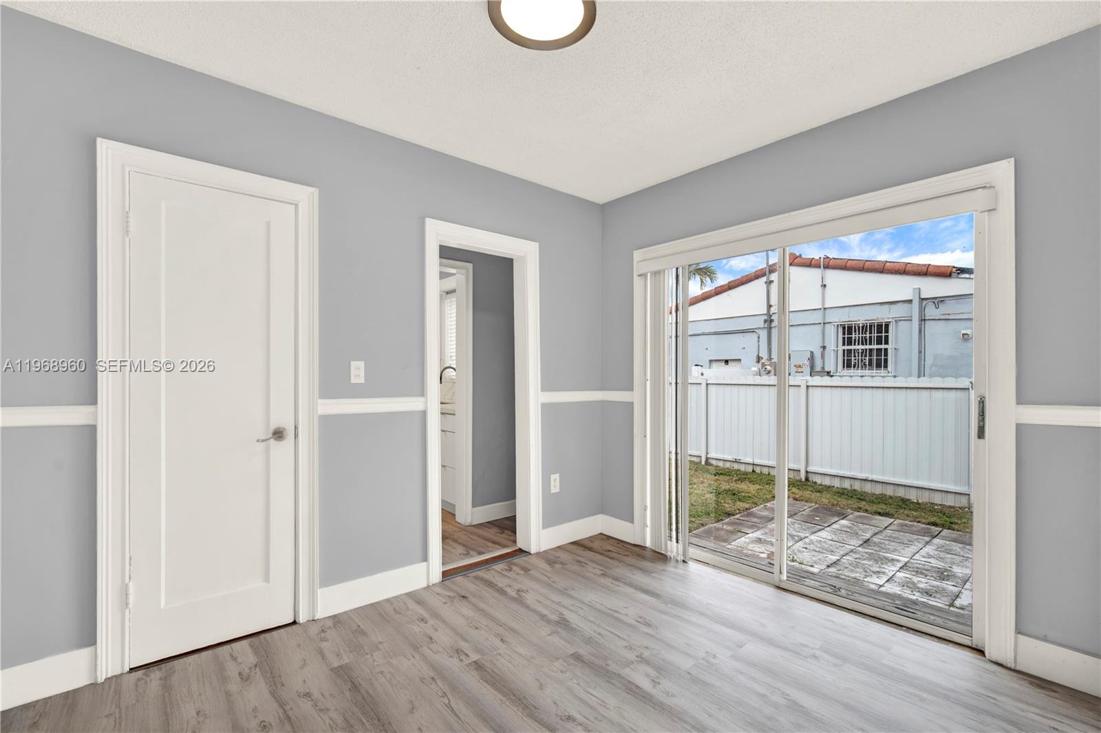 2001 Southwest 37th Avenue Miami, FL 33145 - Photo 16 of 31 an empty room with wooden floor and windows