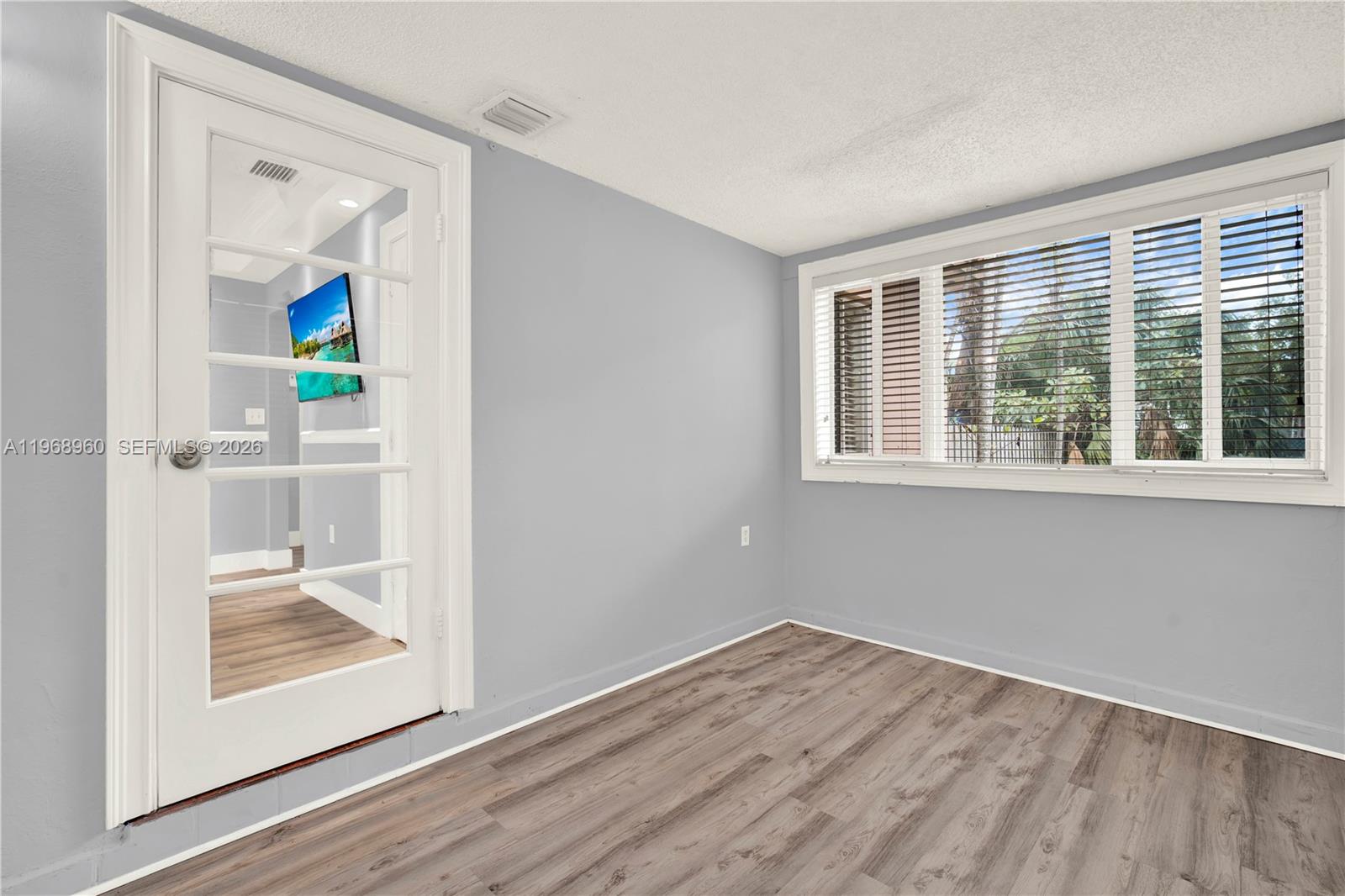 2001 Southwest 37th Avenue Miami, FL 33145 - Photo 17 of 31 an empty room with wooden floor and a window