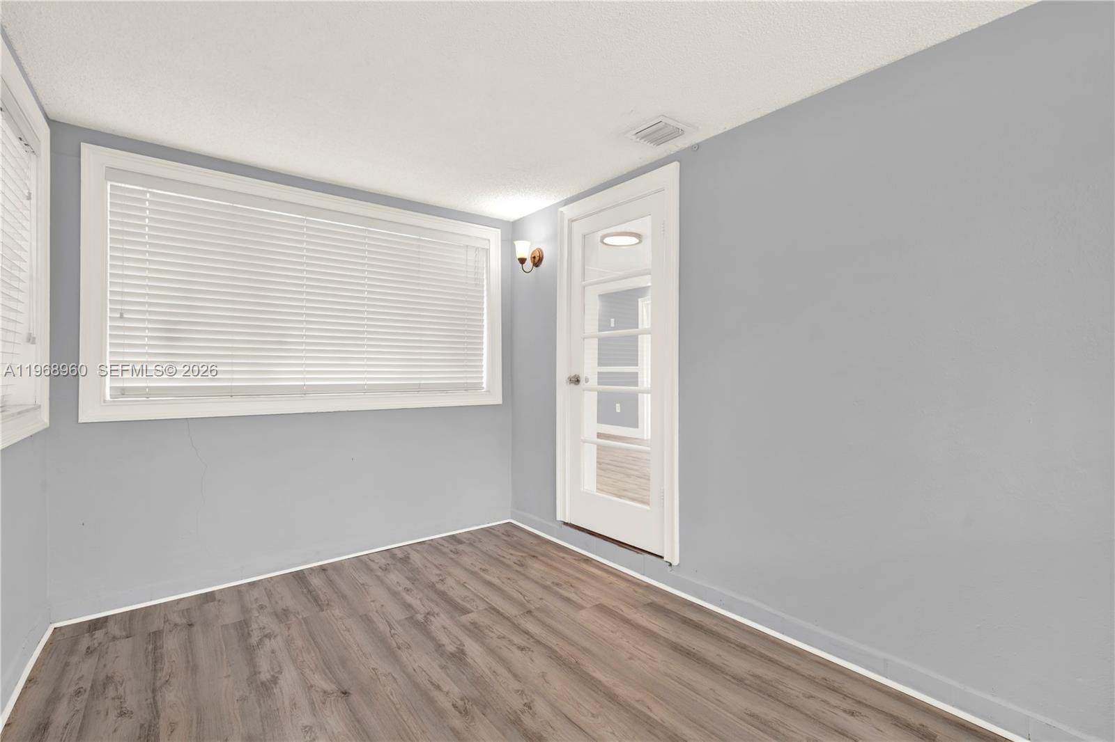 2001 Southwest 37th Avenue Miami, FL 33145 - Photo 18 of 31 an empty room with wooden floor and windows