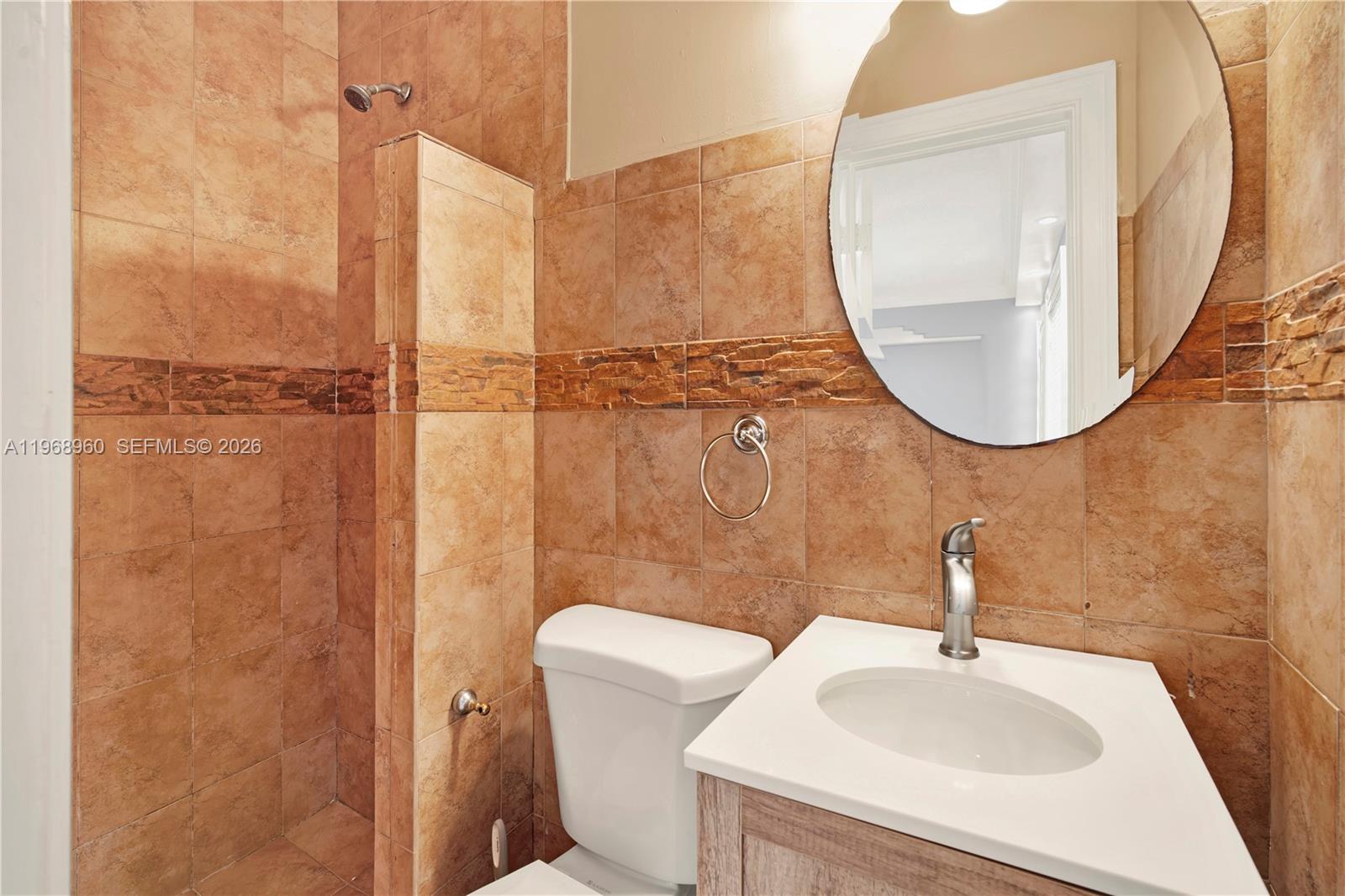 2001 Southwest 37th Avenue Miami, FL 33145 - Photo 19 of 31 a bathroom with a sink a toilet and a mirror