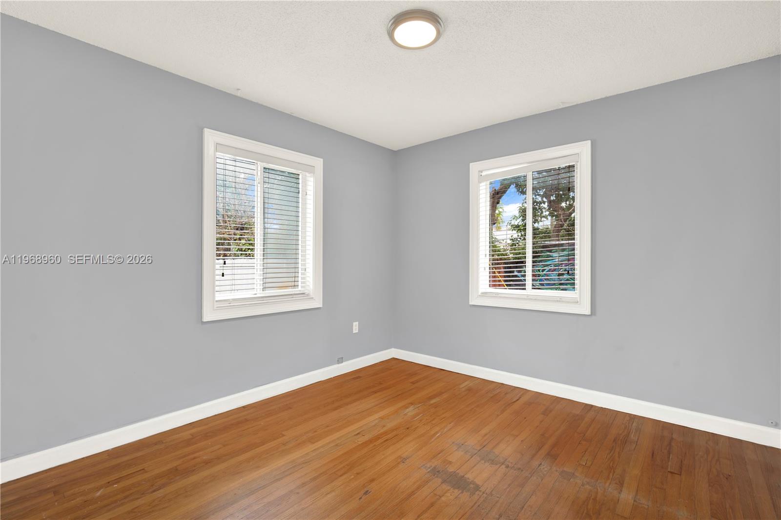 2001 Southwest 37th Avenue Miami, FL 33145 - Photo 22 of 31 an empty room with wooden floor and windows