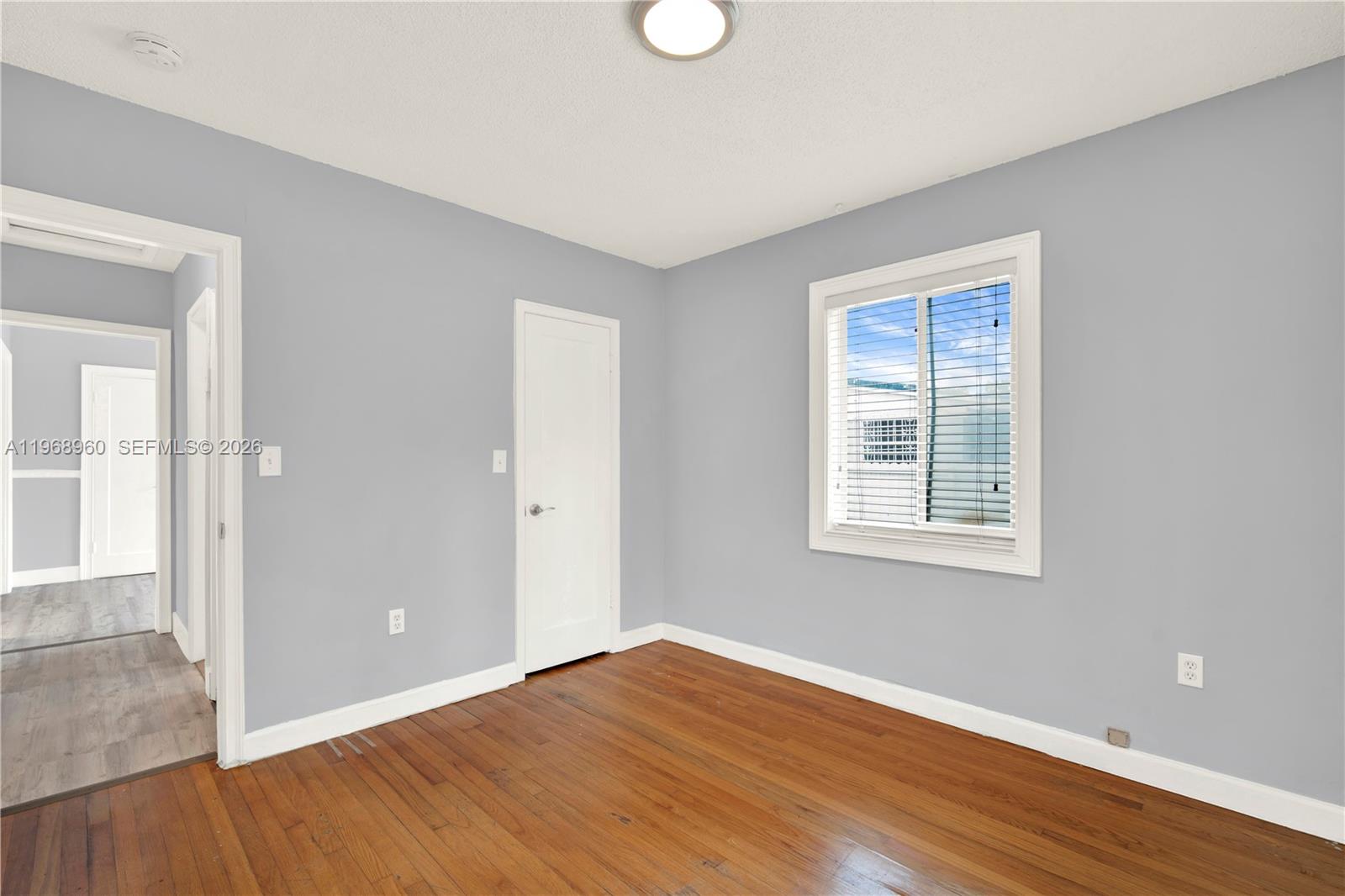 2001 Southwest 37th Avenue Miami, FL 33145 - Photo 23 of 31 an empty room with wooden floor and windows
